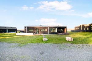 a house with three large rocks in the yard at New Modern Holiday Home Near The Beach in Aabenraa