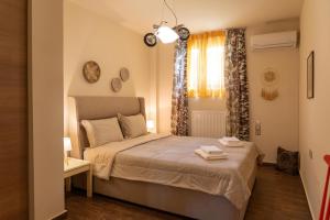 a small bedroom with a bed and a window at Villa Polyxeni Lavender 150m from the sea in Politika