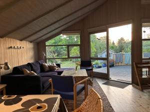 a living room with a couch and a table at Family-Friendly Cottage Near The Beach in Gilleleje