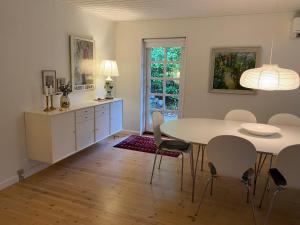 a kitchen and dining room with a table and chairs at Idyllically Situated Wooden House By The Forest in Viborg