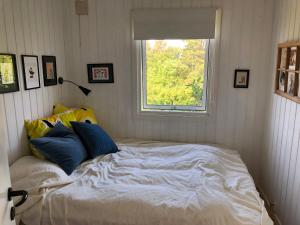 a bed in a room with a window at Nice Summer House With Sea View in Jægerspris