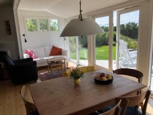 a living room with a wooden table with a bowl of fruit on it at Nice Summer House With Sea View in Jægerspris