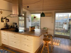 a kitchen with a counter and two bar stools at Family Friendly Holiday Home In Orø in Holbæk
