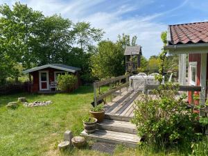 a wooden deck in a yard with a gazebo at Family Friendly Holiday Home In Orø in Holbæk +17 photos