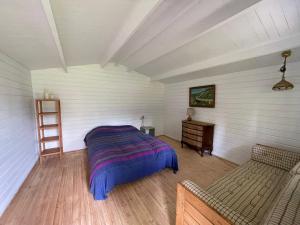 a bedroom with a bed and a desk in a room at Family Friendly Holiday Home In Orø in Holbæk