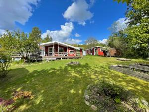 a large yard with a house in the background at Family Friendly Holiday Home In Orø in Holbæk