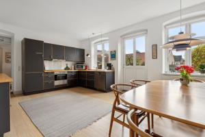 a kitchen and dining room with a table and chairs at Cozy Holiday Home In Marstal On Ærø in Marstal