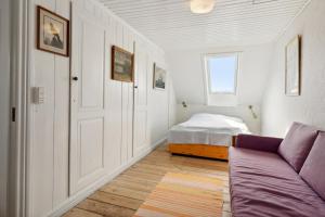 a living room with a bed and a couch at Cozy Holiday Home In Marstal On Ærø in Marstal