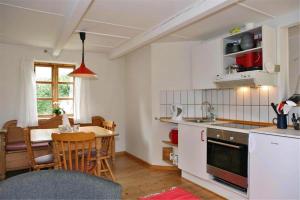 a kitchen with a table and a dining room at Holiday Apartment In Peaceful Surroundings in Neksø