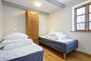 two twin beds in a room with a window at Holiday Apartment In Peaceful Surroundings in Neksø