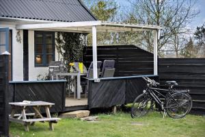 a bike parked on a porch of a house at Holiday Apartment In Peaceful Surroundings in Neksø +8 photos
