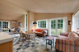 a living room with a couch and a table at Beautiful House 1St Row To The Water in Fur