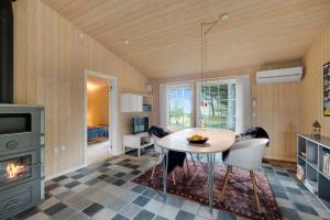 a dining room with a table and a fireplace at Beautiful House 1St Row To The Water in Fur