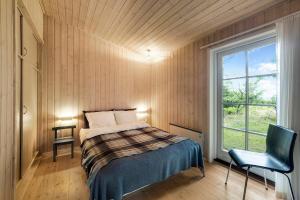 a small bedroom with a bed and a window at Beautiful House 1St Row To The Water in Fur