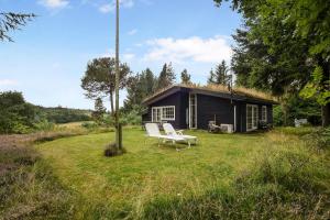 a house with two white chairs in front of it at Beautiful House 1St Row To The Water in Fur