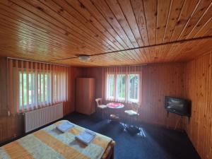 a bedroom with a bed and a tv in it at Casa Iulia si Bogdan in Bran