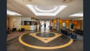 a lobby with a large room with couches and a building at Esplanade 88 in Darwin +8 photos