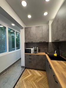 a kitchen with a sink and a microwave at Avliga Designer Residence in Varna City