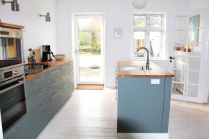 a kitchen with a sink and a counter top at Summer House In Årsdale With A Beautiful Sea View in Svaneke +19 photos