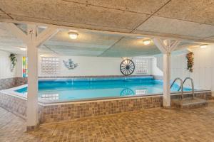 a large swimming pool in a building at Child-Friendly Cottage With Large Indoor Pool in Otterup