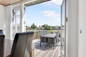 a patio with a table and chairs on a deck at Child-Friendly Cottage With Large Indoor Pool in Otterup