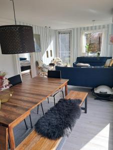 a living room with a table and a couch at Beautiful Holiday Home On An Undisturbed Plot in Rødby