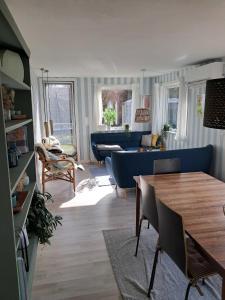 a living room with a blue couch and a table at Beautiful Holiday Home On An Undisturbed Plot in Rødby