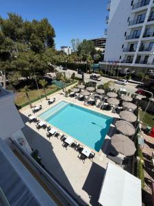 an overhead view of a swimming pool with chairs and umbrellas at Hotel Antik in Golem