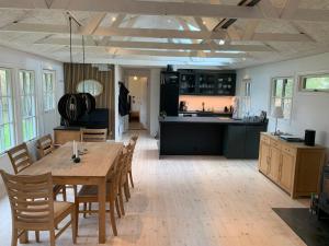 a kitchen and dining room with a table and chairs at Charming Holiday Home At Sought-After Tisvilde in Vejby