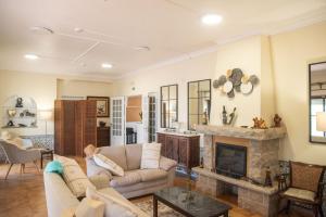 a living room with a couch and a fireplace at Estoril Guest Palace in Estoril