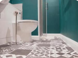 a bathroom with a toilet and a glass shower at Trillberry Guesthouse in Weymouth +23 photos