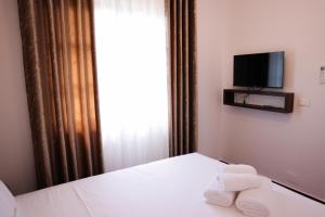 a hotel room with a bed with towels on it at Moin Moin Boutique Hotel in Berat +67 photos
