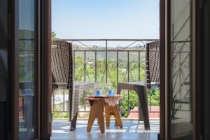 a table and chairs on a balcony with a view at StayinPyrgi in Pyrgi