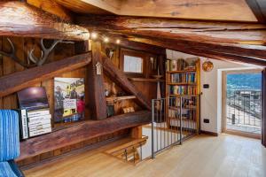 a living room with wooden walls and wooden beams at Casa Piertor Morgex in Morgex