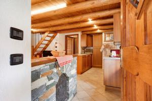 a kitchen with wooden ceilings and a stone counter top at Casa Piertor Morgex in Morgex