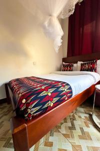 a bed with a colorful blanket on top of it at Serenus Lounge in Senge +27 photos