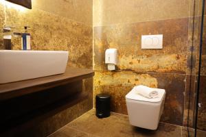 a bathroom with a white toilet and a sink at Moin Moin Boutique Hotel in Berat
