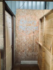 a wall with graffiti on it next to a door at Flow Dome at Estuary Escapes in Kingsbridge +25 photos