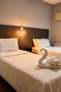 a swan sitting on a bed in a hotel room at Essencial Hotel Spa in Mendoza