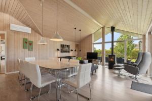 a dining room and living room with a table and chairs at Activity House - Flovt Strand Haderslev in Haderslev
