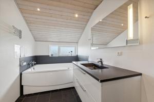 a bathroom with a sink and a bath tub at Activity House - Flovt Strand Haderslev in Haderslev +20 photos