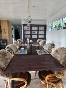 a dining room with a large wooden table and chairs at Cozy Cottage Only 500 M From The Sea in Gilleleje