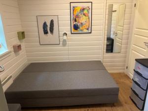 a bedroom with a bed in the corner of a room at Summer Cottage With Jacuzzi And Sauna in Fakse Ladeplads +6 photos