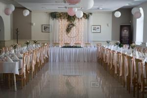 a banquet hall with tables and chairs with white tablecloths at Belvárdi Fogadó in Belvárdgyula