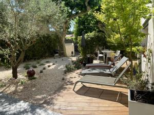 a row of chaise lounges on a wooden deck at Le Valat in Saze