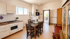 a kitchen and dining room with a table and chairs at Casa Vacanze Agriturismo BioMele in Policoro