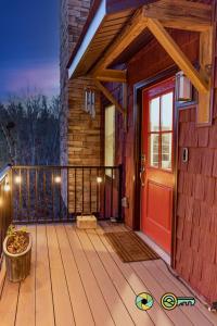 a house with a red door on a deck at 324 Brian Drive: The Swirling Bird in Basye