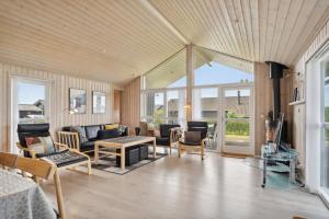 a living room with a couch and a table at Lovely Summer House In Haderslev in Haderslev