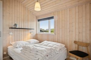 a bedroom with a bed in a room with a window at Lovely Summer House In Haderslev in Haderslev