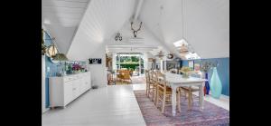 a kitchen with a table and a dining room at Cozy Holiday Home With Character in Nakskov